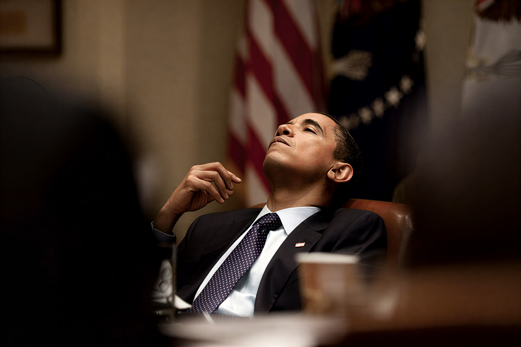 Obama slumps or relaxes on chair